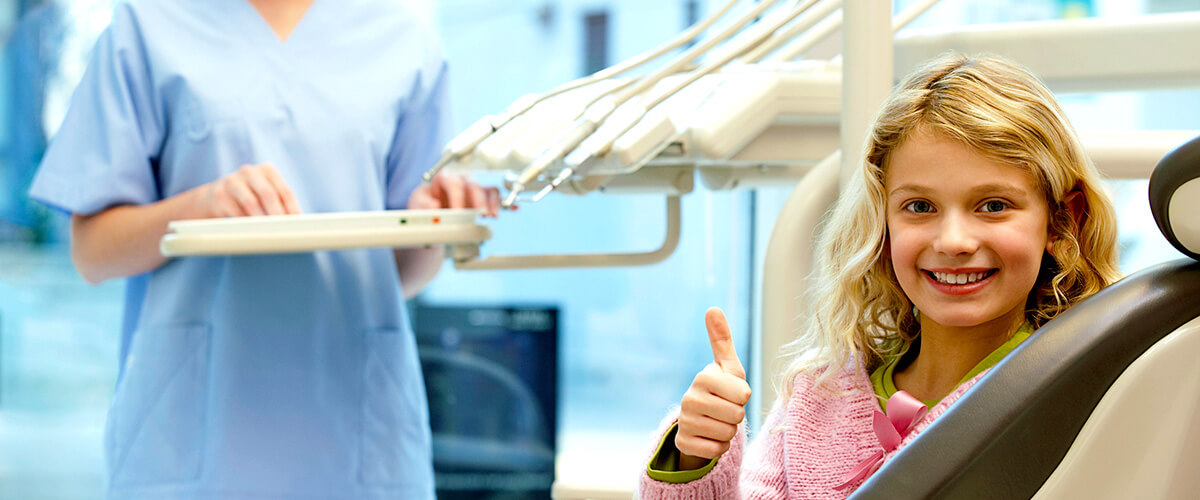 Girl smiling with thumbs up